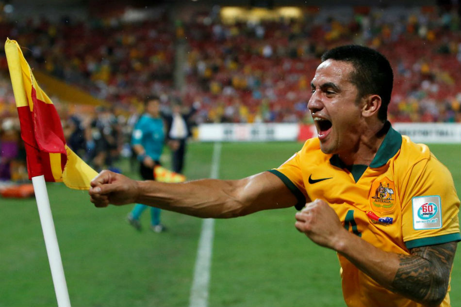 Tim Cahill uses the corner flag as a punching bag during his trademark celebration.