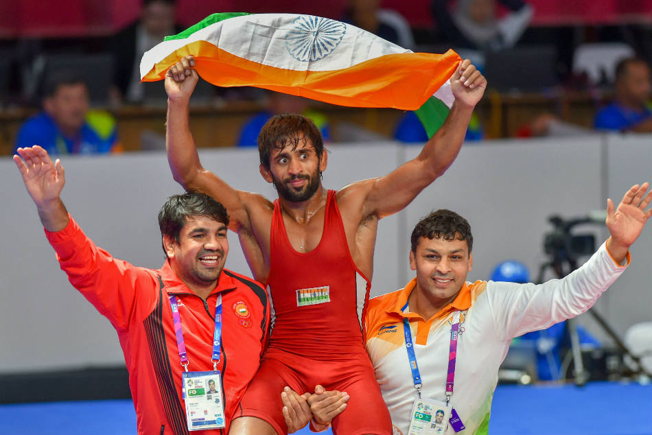 Indias Bajrang Punia carries the tricolour after winning the gold in the mens freestyle wrestling (65kg) at the Asian Games 2018 in Jakarta on Sunday