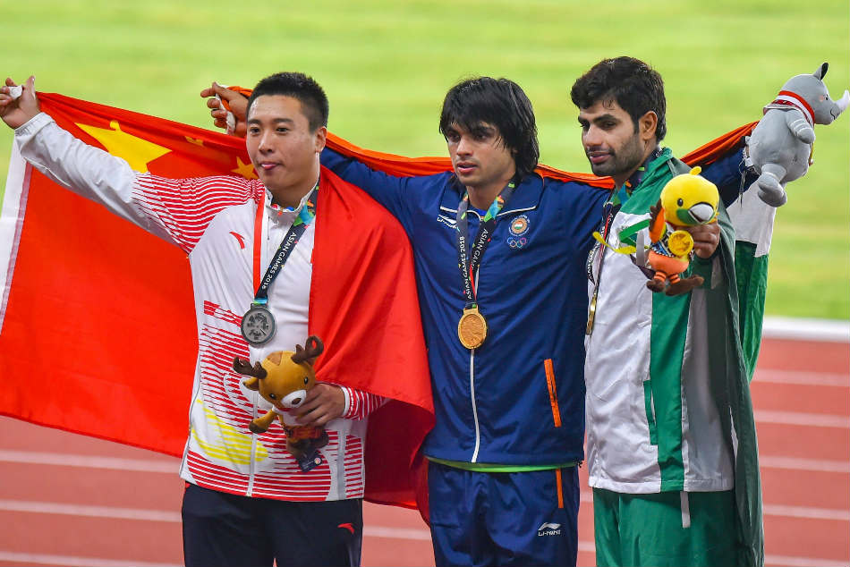 Neeraj Chopra (centre) after winning Gold medal at 2018 Asian Games