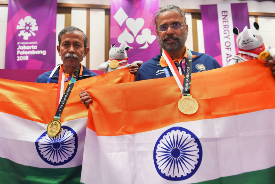 Pranab Bardhan (left) and Shibhnath Sarkar pose after winning the gold medal in the Mens Pair Bridge event at the Asian Games 2018