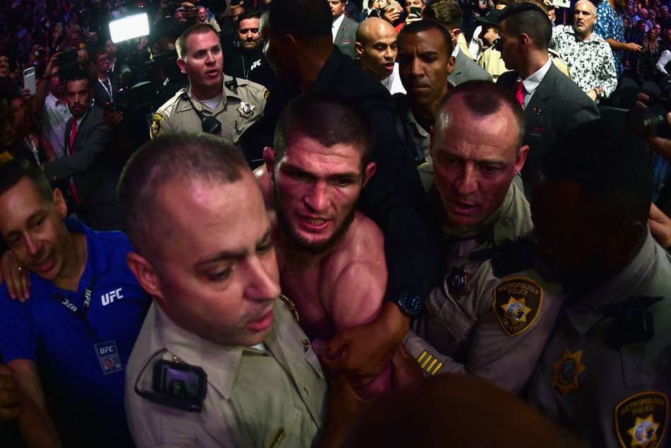 Khabib Nurmagomedov escorted by security after UFC 229 main event Khabib Nurmagomedov escorted by security after UFC 229 main event