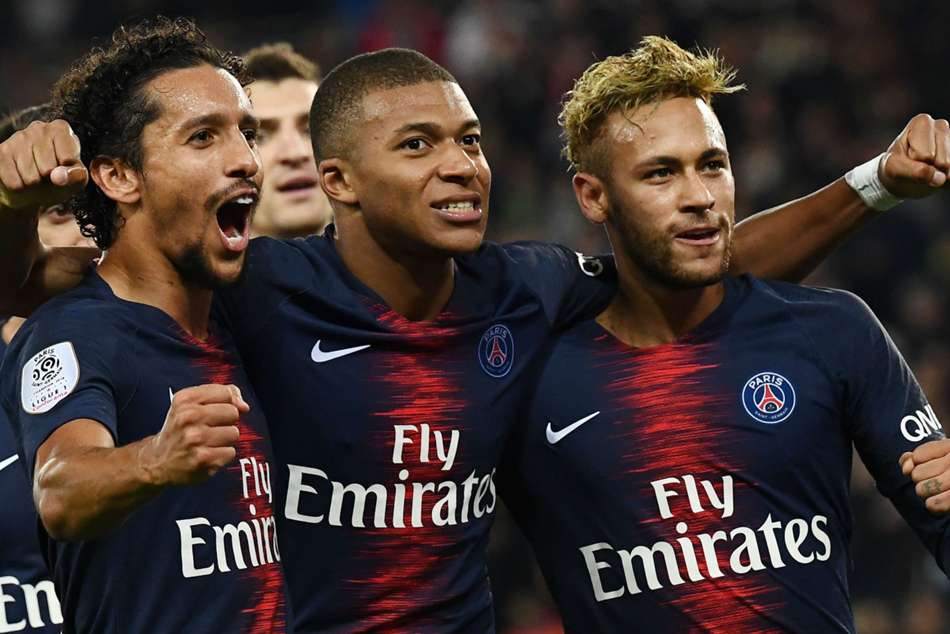 PSG star Kylian Mbappe (centre) celebrates with teammates during win over Lyon PSG star Kylian Mbappe (centre) celebrates with teammates during win over Lyon