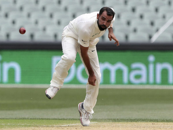3. Bumrah stands with Shami