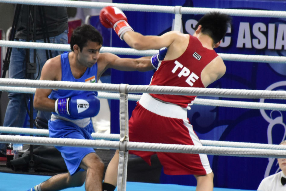 Amit Panghal lands a power punch on his opponent as he wins his fist bout at the Asian Championships. Amit Panghal lands a power punch on his opponent as he wins his fist bout at the Asian Championships.