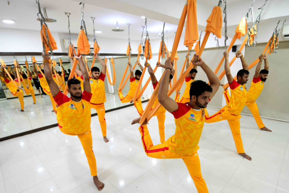 Gujarat Fortunegiant players perform Yoga