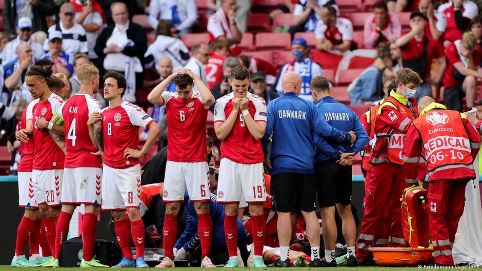 Emotional Denmark players form a protective ring around Christian Eriksen