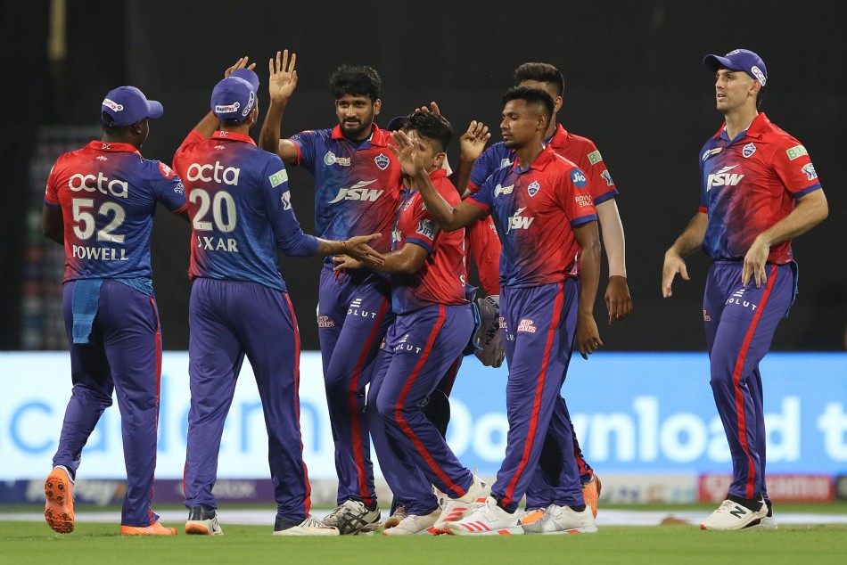 Delhi Capitals players celebrate fall of a wicket
