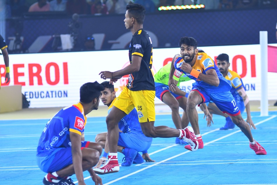 Telugu Yoddhas Prajwal KH chases Avik Singha of Mumbai Khiladis during a Ultimate Kho Kho match 