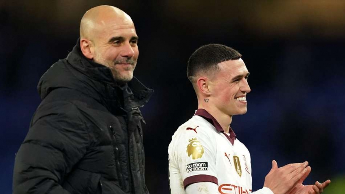 Manchester City manager Pep Guardiola with in-form Phil Foden