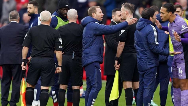 Referee Paul Tierney is surrouned by Nottingham Forest players and staff