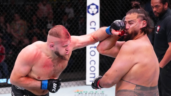 L-R Marcin Tybura punches Tai Tuivasa during the UFC Vegas 88 main event Photo by Jeff Bottari Zuffa LLC via Getty Images