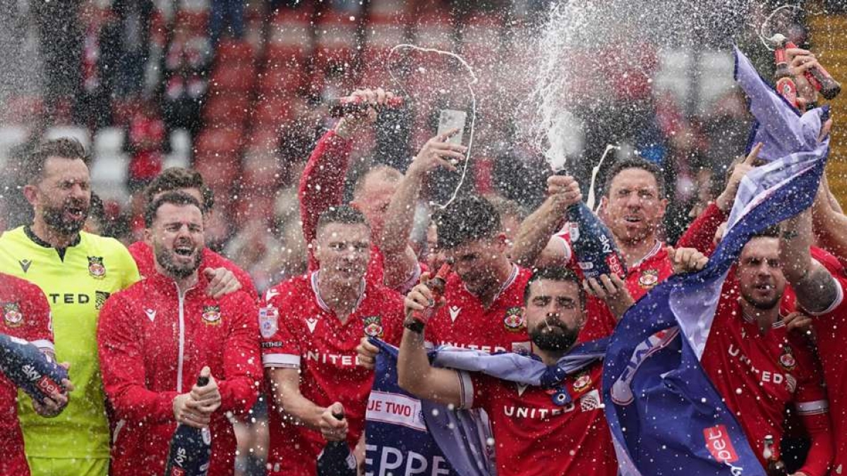 Wrexham players celebrate their promotion