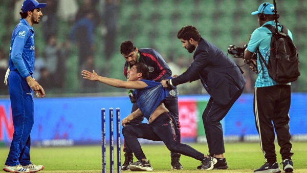 Pitch invader being ushered away by security personnel during Afghanistan vs England Champions Trophy match Image Courtesy X