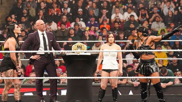 Rhea Ripley Bianca Belair and Iyo Sky signed the contract for their WrestleMania match on WWE Raw Image Courtesy WWE com