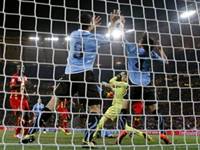 Uruguay's Luis Suarez, left, touches the ball with his hands to give away a penalty during the World Cup quarterfinal soccer match between Uruguay and Ghana at Soccer City in Johannesburg, Uruguay's Luis Suarez, left, touches the ball with his hands to give away a penalty during the World Cup quarterfinal soccer match between Uruguay and Ghana at Soccer City in Johannesburg,
