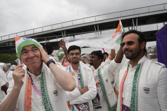 Indian athletes travel in a boat on the Seine River in Paris, France, during the opening ceremony of the 2024 Summer Olympics, Friday, July 26, 2024.