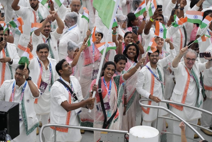 India's Sharath Kamal Achanta and V. Sindhu Pusarla wave as they travel with teammates down the Seine River in Paris, France, during the opening ceremony of the 2024 Summer Olympics, Friday, July 26, 2024