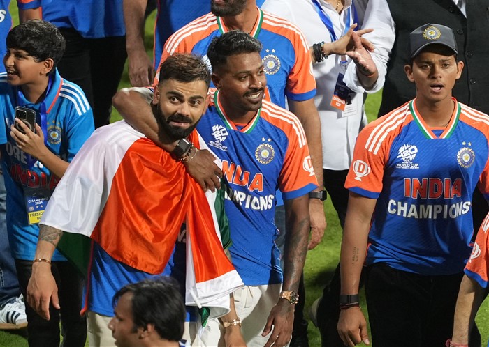 Players of the T20 World Cup-winning Indian cricket team Virat Kohli, Hardik Panya and Yashasvi Jaiswal take a victory lap during their felicitation ceremony at the Wankhede Stadium.