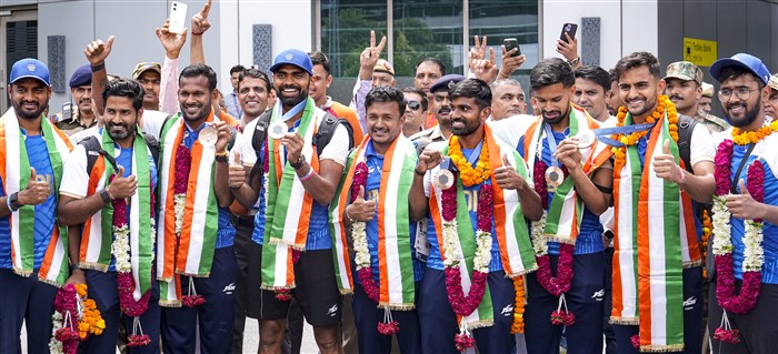 Paris Olympics Bronze medallist Indian Hockey player PR Sreejesh along with his team poses for photos on their arrival at the Indira Gandhi International Airport, in New Delhi.