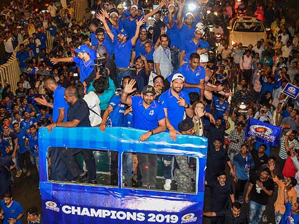 Mumbai indians players greeted by their fans during an open top bus ride 