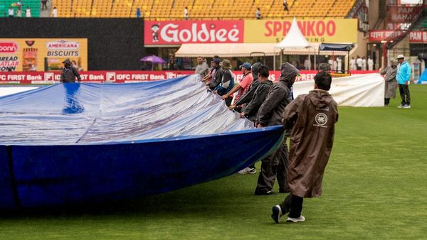 Ground staff covering pitch at Dharamsala stadium during rain Ground staff covering pitch at Dharamsala stadium during rain