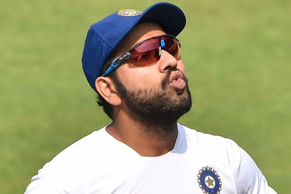 Cameras catch Rohit Sharma eating while hiding behind a support staff member on bench during second T20I against England Cameras catch Rohit Sharma eating while hiding behind a support staff member on bench during second T20I against England