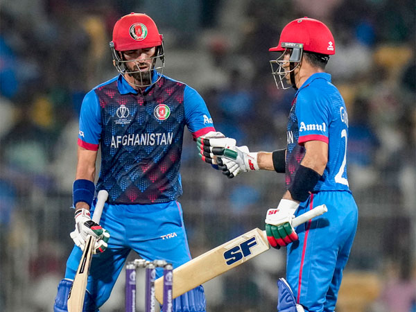 Rahmanullah Gurbaz being congratulated by teammate Ibrahim Zadran 